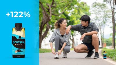 Couple about to start jogging in the forest, Tetra Prisma carton with protein drink