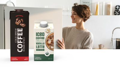 Woman in kitchen, ice coffee in Tetra Brik Aseptic and  Tetra Rex gable top carton packages