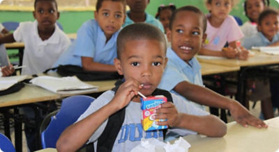 Child drinking from a carton