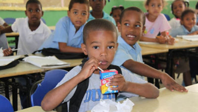 Boy drinking milk at school