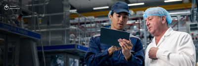 Tetra Pak expert and customer looking at tablet 