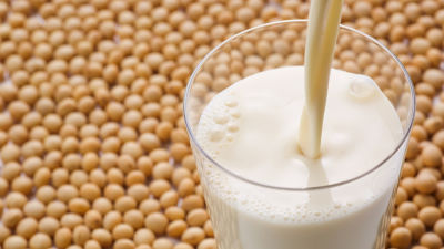 Soya milk in glass and beans