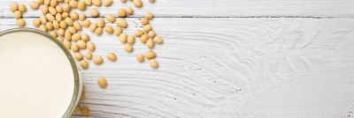 Soya beverage and soya beans on a table