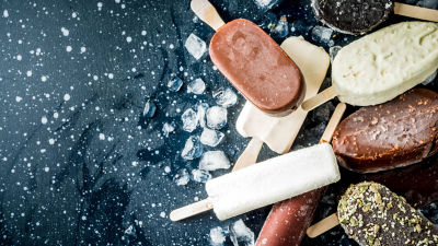 Ice cream stick laying on blackberries