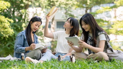 Students in park, coffee drink in Tetra Prisma Aseptic carton package