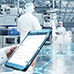 Operator with tablet, operators in plant