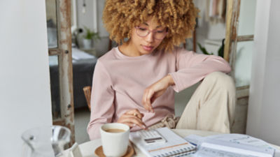 woman drinking tea with newspaper