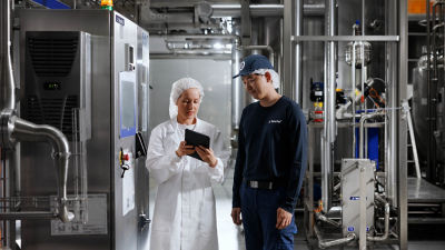 Two employees in a factory setting