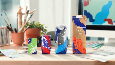 Tetra Prisma carton packages with different designs on desk