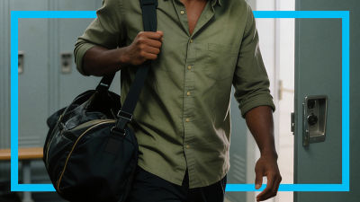 Man at gym holding a bag.