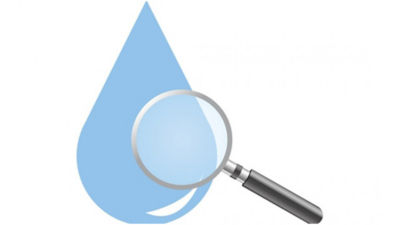 Magnifying glass in front of water droplet