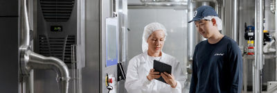 Woman and man in cheese production.