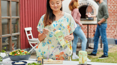 Woman and Tetra Recart package with pear halves