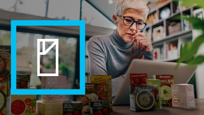 Woman with computer, Tetra Recart carton packages on her desk