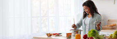 Woman cooking, soup in Tetra Recart carton
