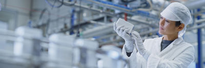 Female operator inspecting carton package