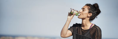 Woman drinking out of a carton