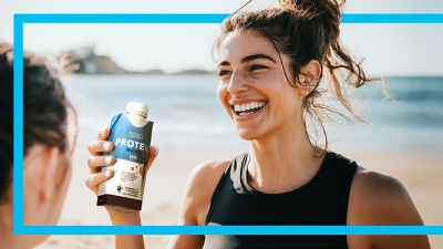 Young women with protein drink in Tetra Prisma Aseptic carton package