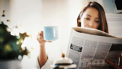 Woman reading newspaper