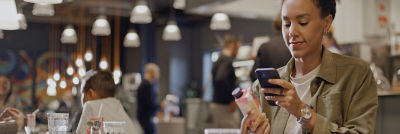 Woman scanning QR code on carton package