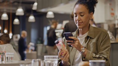 Woman scanning QR code on carton package