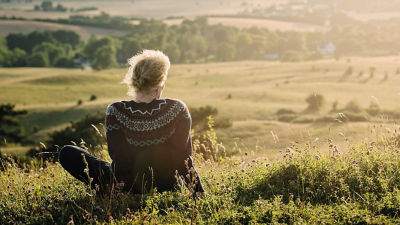 Woman sitting a hill