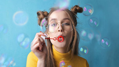 Woman blowing soap bubbles
