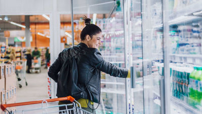 Woman buying milk in a supermarket