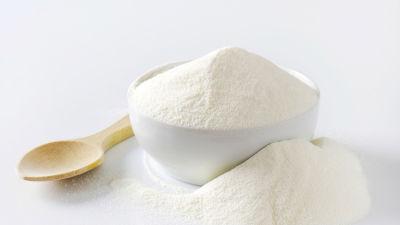 white powder milk with wooden spoon