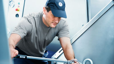 a person fixing something at a factory
