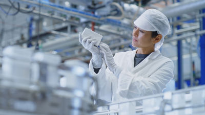 a person looking at an object at a factory
