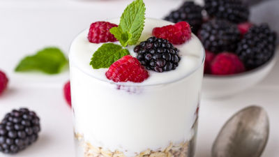 a glass with yoghurt and berries