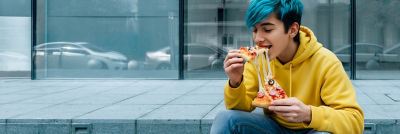 Young man eating pizza