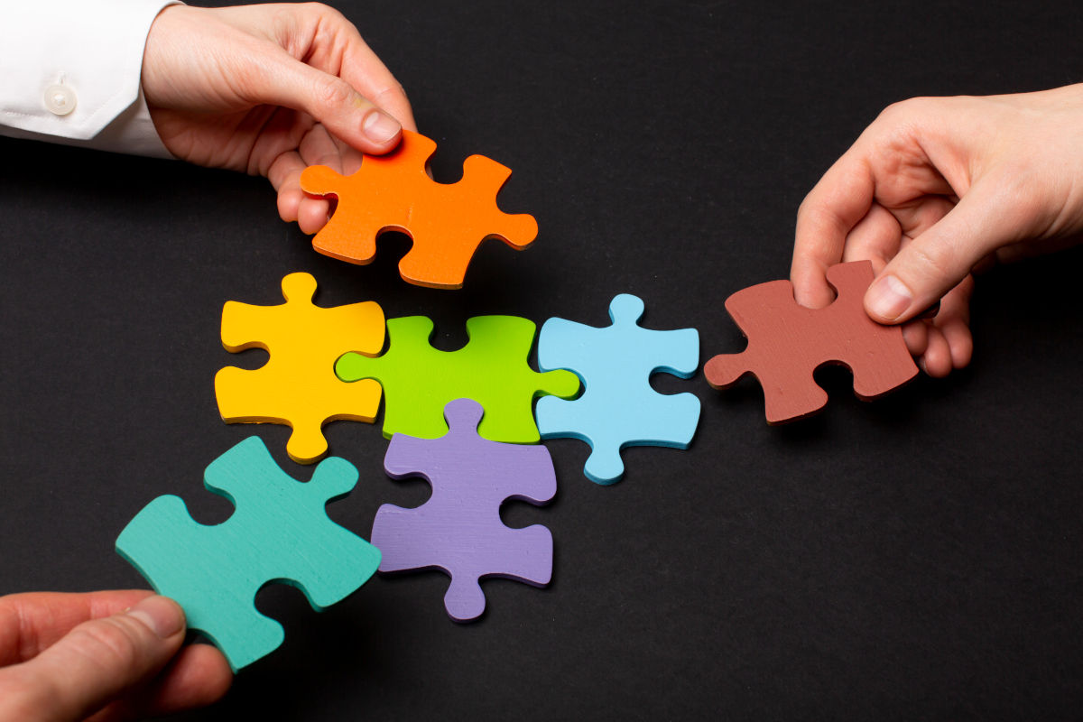 mani che tengono tessere puzzle