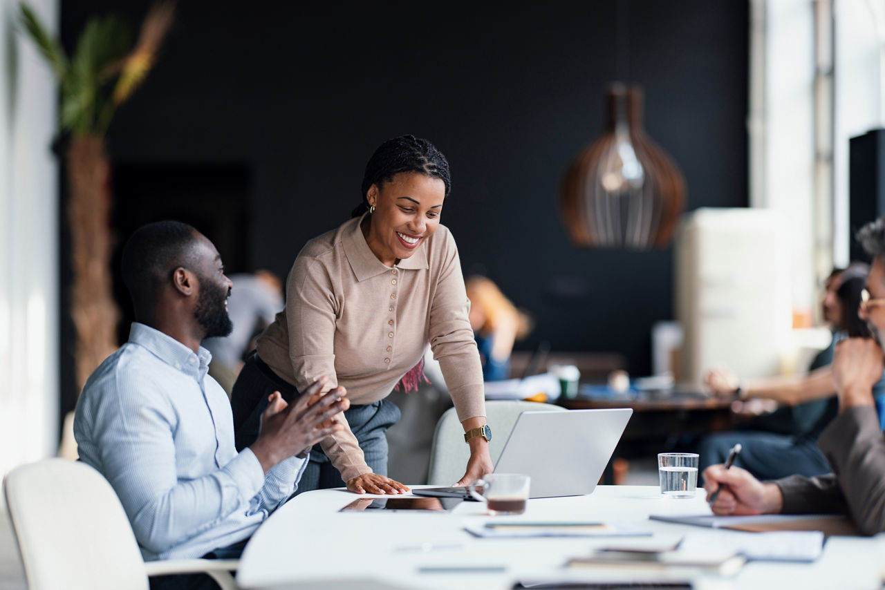 Business professionals working together in a collaborative office space, fostering creativity and teamwork while discussing innovative strategies for success.