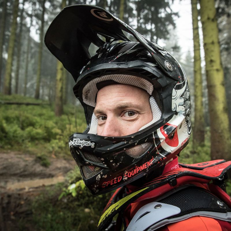 Christian Junker with helmet and opened visor in portrait