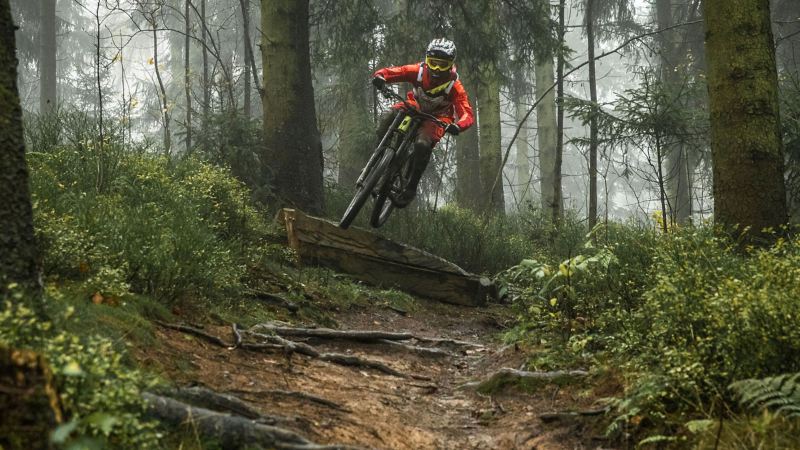 Christian Junker is riding his mountain bike down a slope