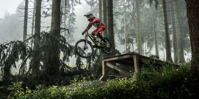 Christian Junker is riding his mountain bike down a slope
