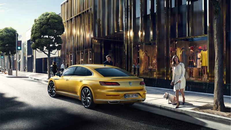 VW Arteon parking in front of a shop