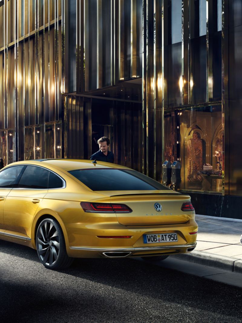 VW Arteon parking in front of a shop