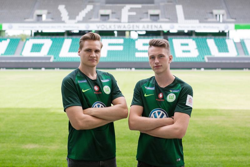 “FIFA” sportsmen Benedikt Saltzer and Timo Siep standing in the VfL Wolfsburg stadium.