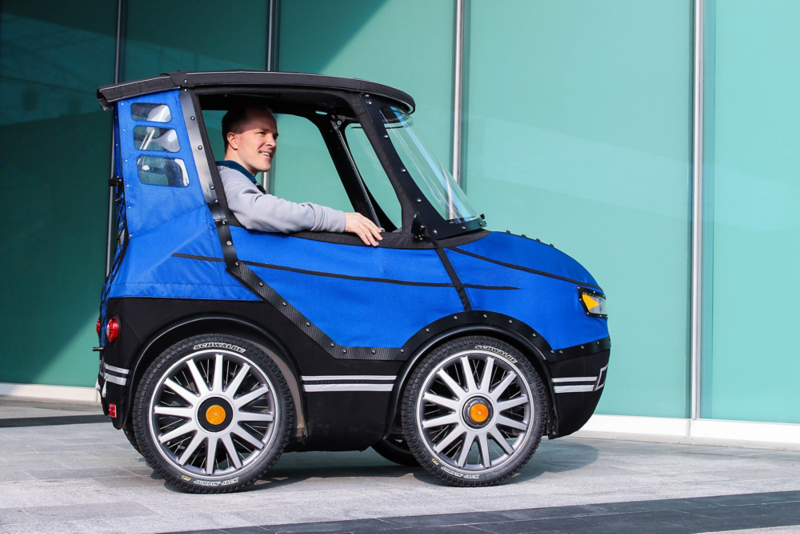 The inventor, Mikael Kjellman, sits in his “PodRide”