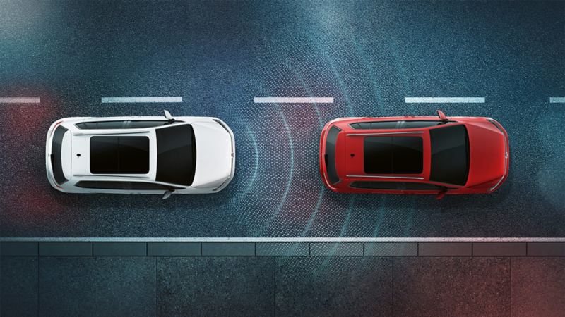 Two Volkswagen vehicles seen from above at night. Schematic view of the Adaptive Cruise Control ACC sensor system
