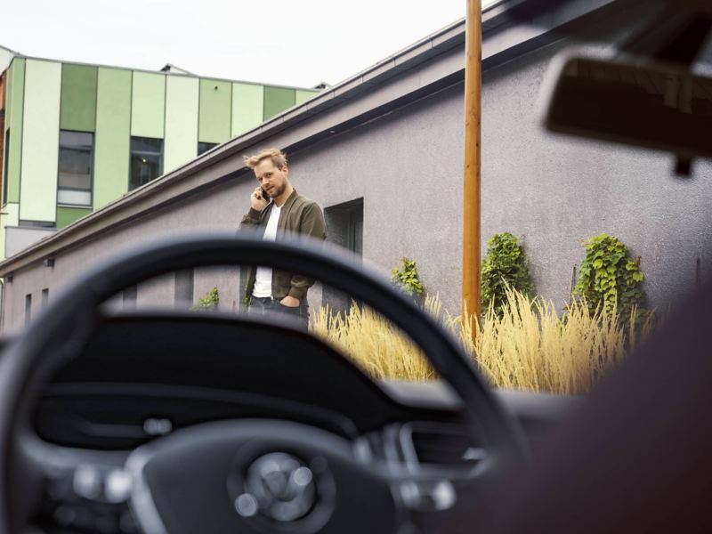 Man in front of the VW car, link out to VW’s “warranties & coverage” page