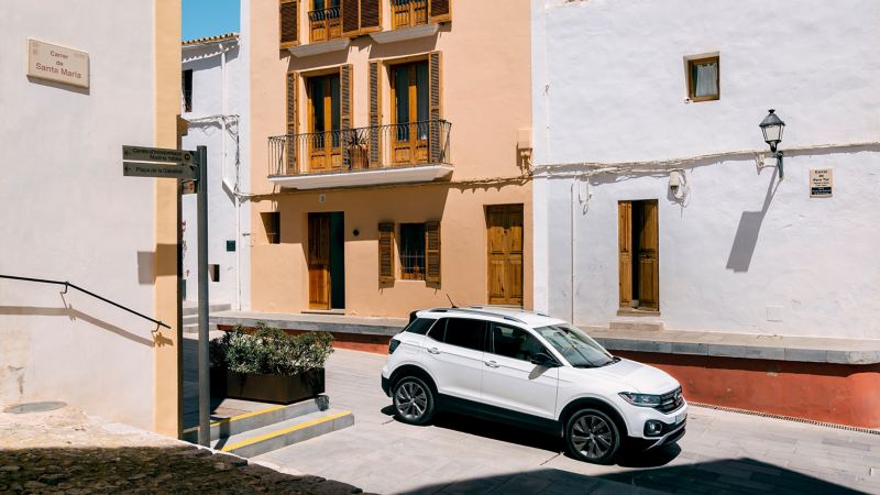 The T-Cross by day in front of colorful Ibiza facades