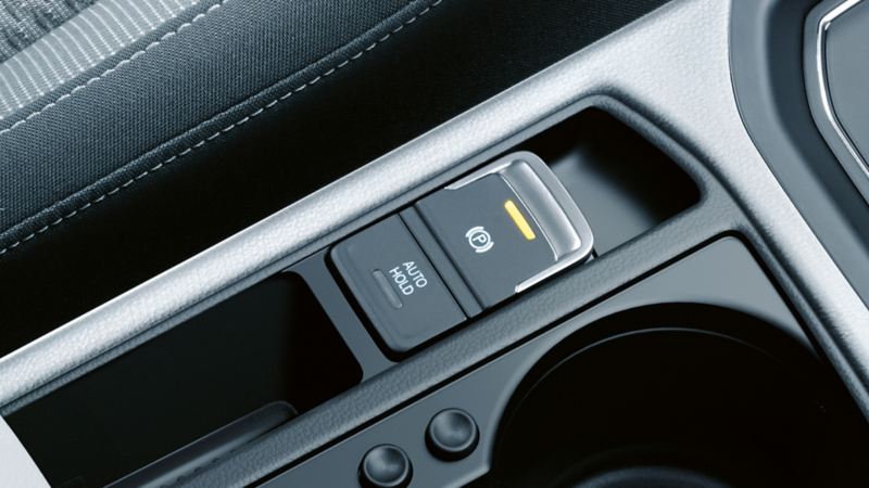 Interior view of a Volkswagen with focus on the dynamic parking brake auto release function on the