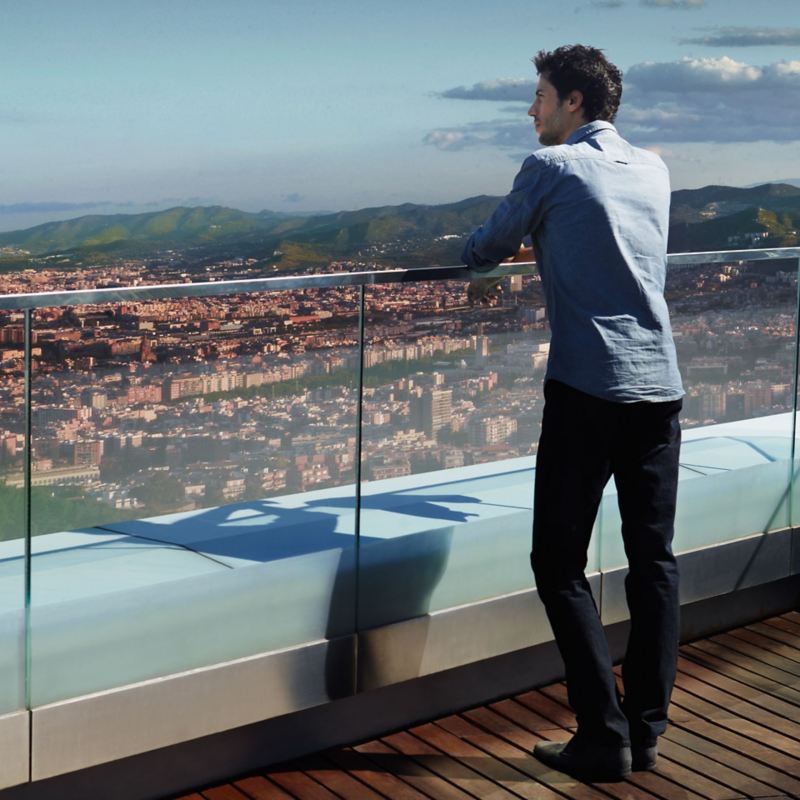 A man on a roof top enjoys the view of a city – WLTP test procedure