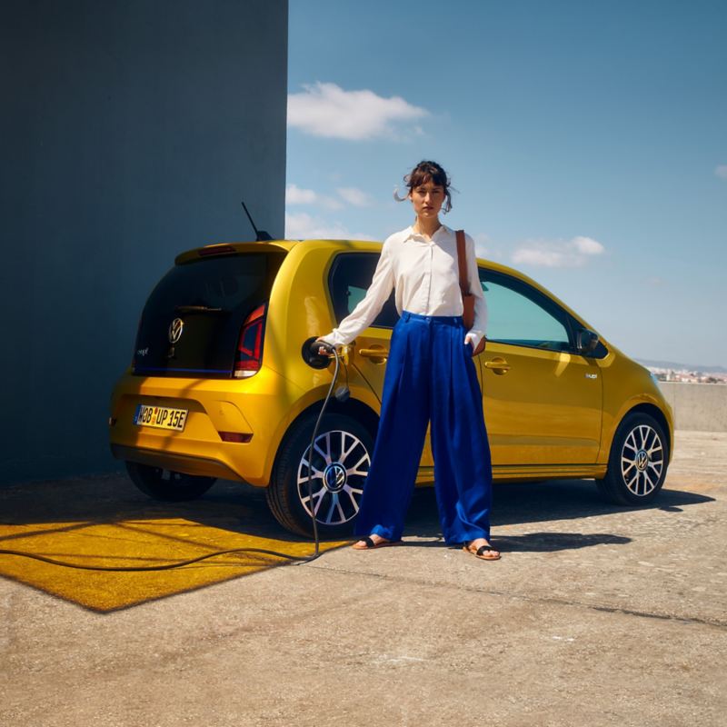 Woman charges the VW e-up! at a wallbox