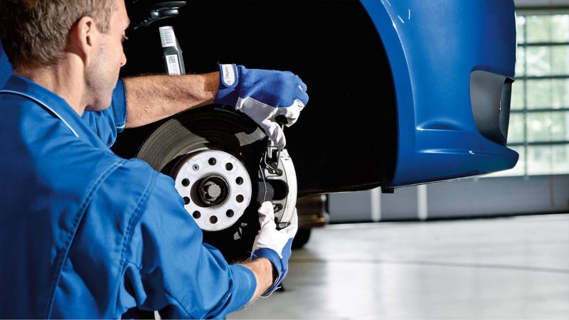 Technician working on van brake disc