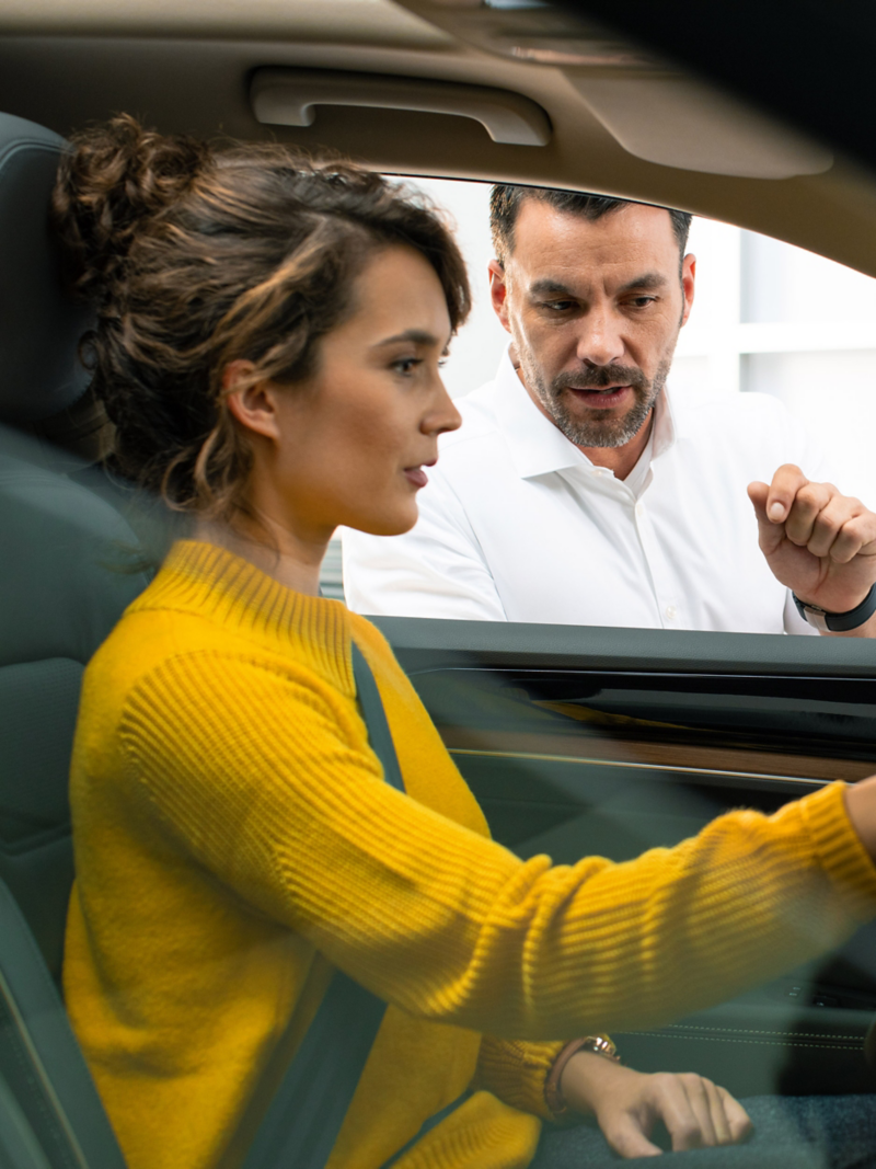 Man talking to woman in car